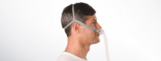 Man wearing nasal pillow CPAP Mask